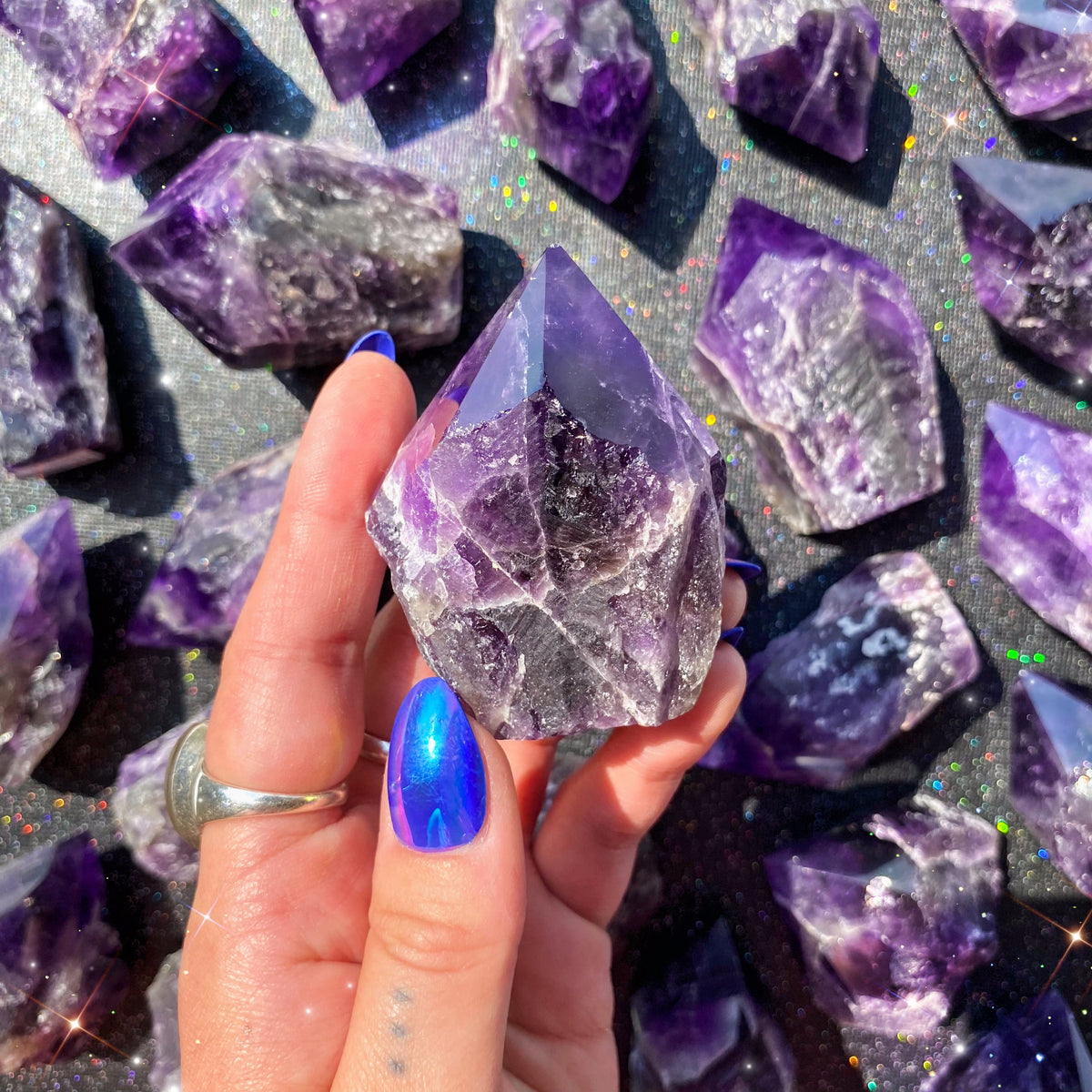 Vivid, small sized, purple Amethyst that is raw with a polished point at the top. 